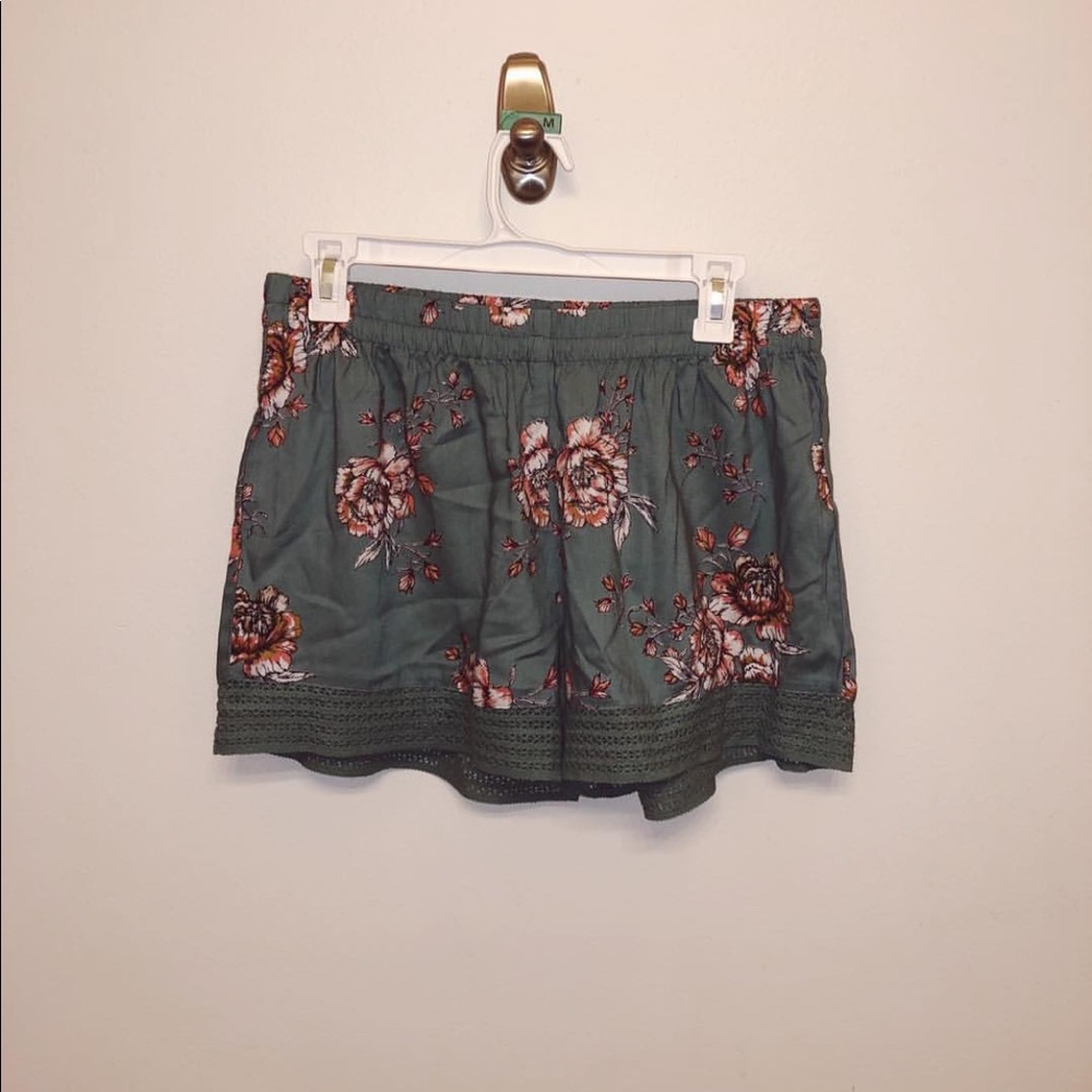 Green shorts with floral design and bottom details